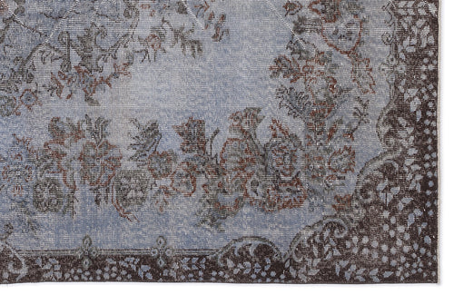 Load image 1 in gallery view. Distressed light blue rug with a dark brown floral medallion pattern and ornate border.