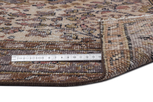 Load image 1 in gallery view. Beige and brown traditional rug with a floral medallion pattern, shown with a metal ruler for scale on a white background.