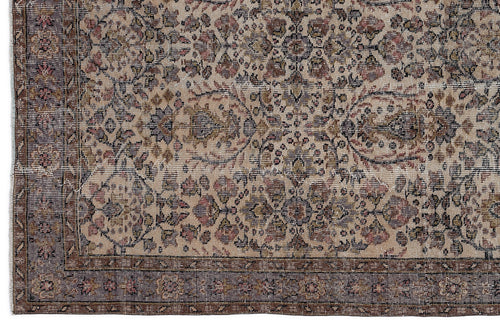Load image 1 in gallery view. Beige and brown traditional rug with a distressed floral medallion pattern and a dark bordered edge.