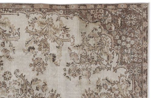 Load image 1 in gallery view. Beige and brown vintage-style rug with a distressed floral medallion pattern and a detailed border.