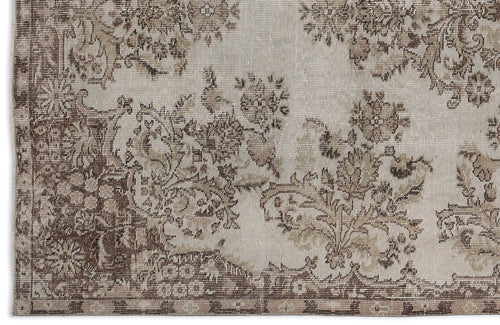 Load image 1 in gallery view. Beige and brown distressed rug with a faded floral medallion pattern and a decorative border.