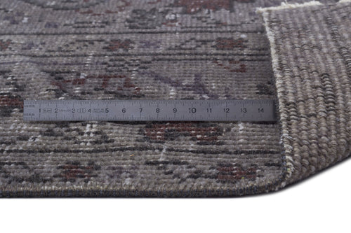 Load image 1 in gallery view. Grey and brown distressed traditional rug with a folded corner and a metal ruler for scale.