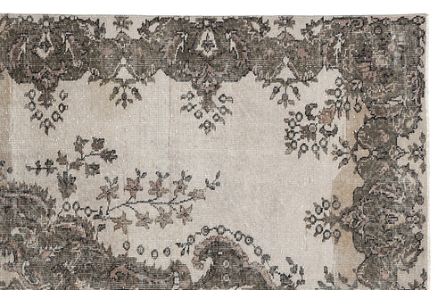 Load image 1 in gallery view. Distressed beige and charcoal grey rug with a traditional floral border and central medallion motif.