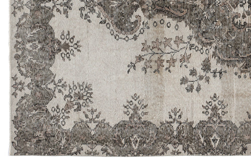 Load image 1 in gallery view. Distressed charcoal and cream rug featuring a traditional floral medallion pattern with ornate borders.