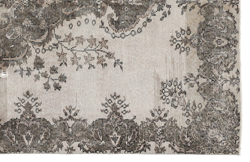 Load image 1 in gallery view. Distressed charcoal and cream rug with a traditional floral medallion and vine pattern.