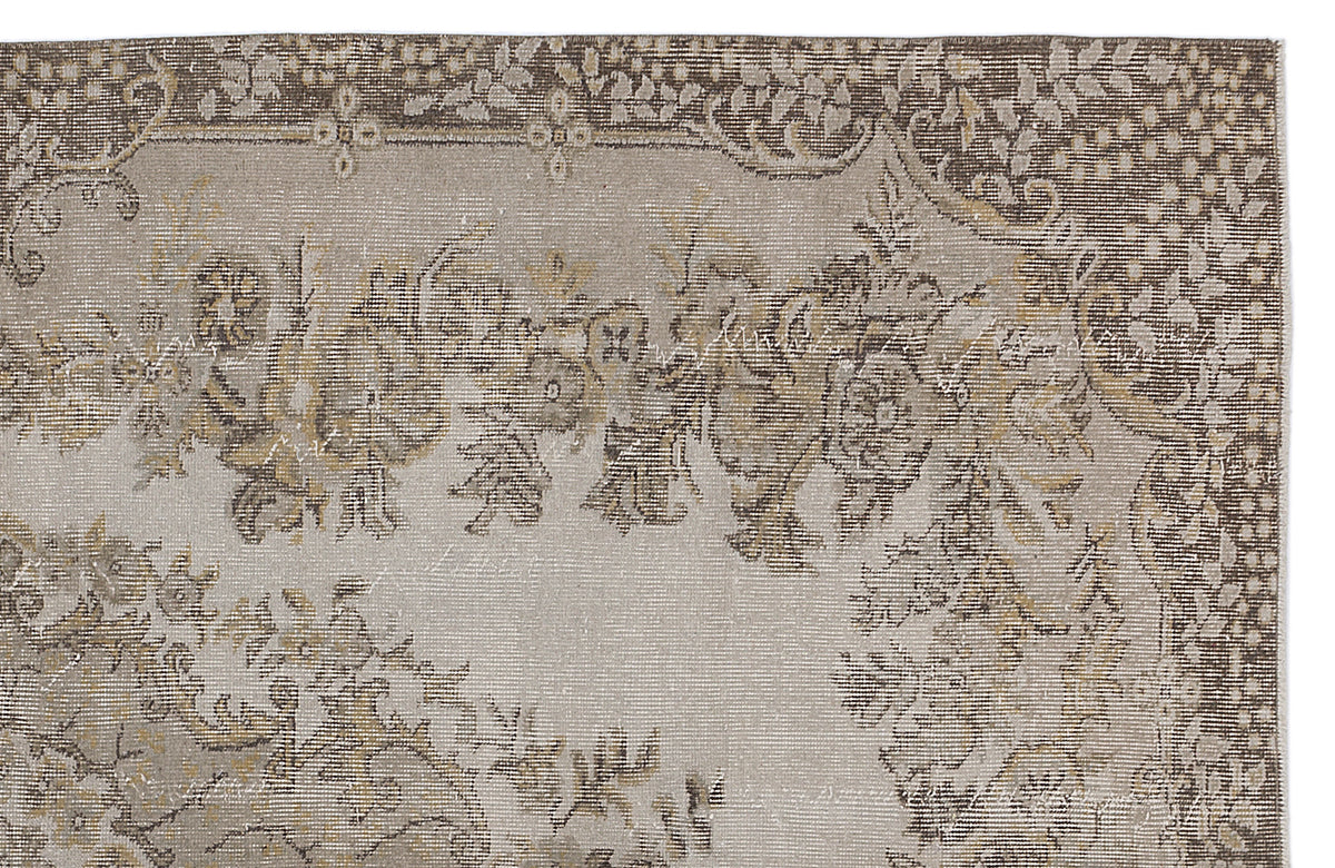 Beige and brown vintage-style rug with a distressed floral medallion pattern on a white background.