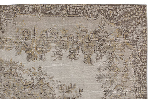 Load image 1 in gallery view. Beige and brown vintage-style rug with a distressed floral medallion pattern on a white background.