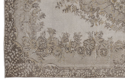 Load image 1 in gallery view. Taupe and beige rug with a distressed floral medallion pattern and a detailed border.