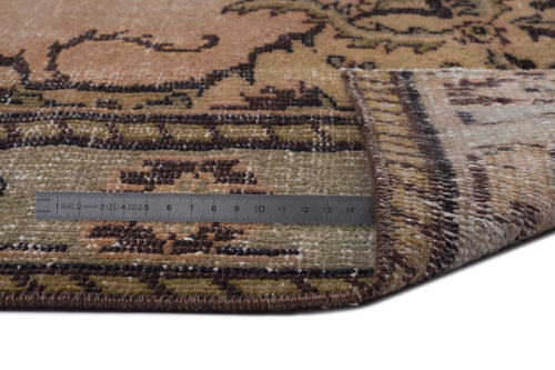Load image 1 in gallery view. Tan, olive, and brown vintage-style rug with a floral border, shown with a metal ruler for scale.