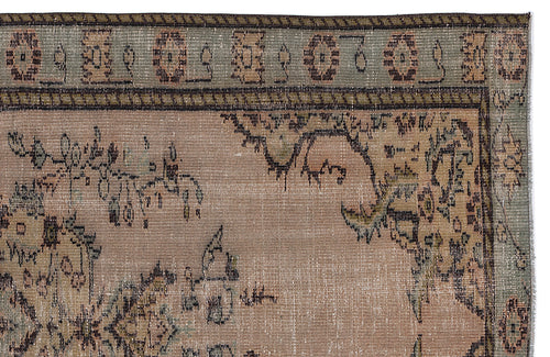 Load image 1 in gallery view. Distressed beige and sage green rug with a traditional floral medallion border and central botanical motifs.