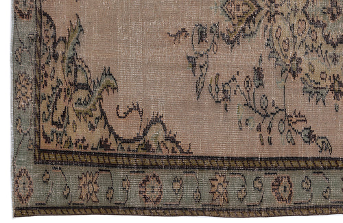 Load image 1 in gallery view. Distressed beige rug with a faded floral medallion pattern and a sage green border featuring geometric motifs.