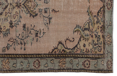 Load image 1 in gallery view. Distressed dusty rose rug with muted green and charcoal floral medallion patterns and a decorative border.
