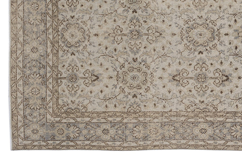 Load image 1 in gallery view. Beige and grey traditional rug with a distressed floral medallion pattern and a geometric border.