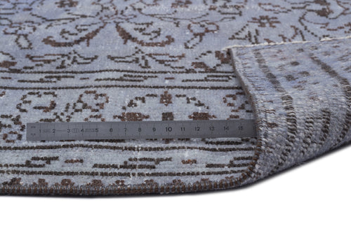 Load image 1 in gallery view. Light blue and brown traditional floral pattern rug with a folded corner and a metal ruler for scale.
