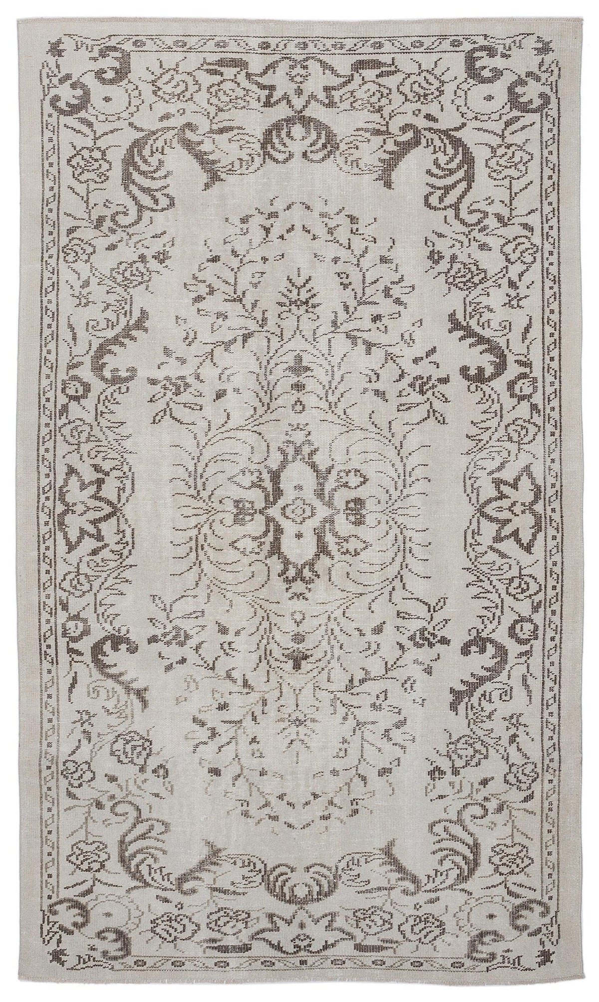 Light beige rug with a dark brown floral medallion and ornate botanical border pattern.