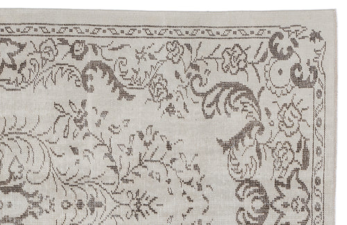 Load image 1 in gallery view. Beige rug with a dark brown floral and vine pattern in a traditional woven style on a white background.
