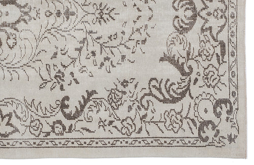 Load image 1 in gallery view. Beige and taupe rug with a distressed floral medallion pattern and a decorative border.