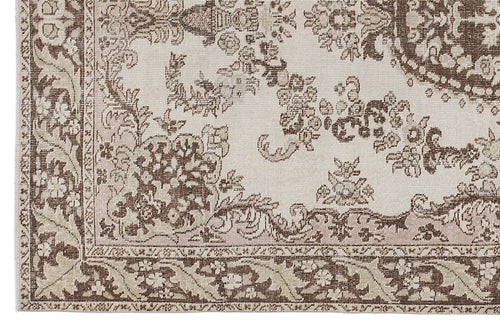 Load image 1 in gallery view. Beige and brown traditional rug with a distressed floral medallion pattern and a detailed border.
