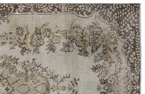 Load image 1 in gallery view. Distressed beige and brown rug with a traditional floral medallion pattern and a dark decorative border.