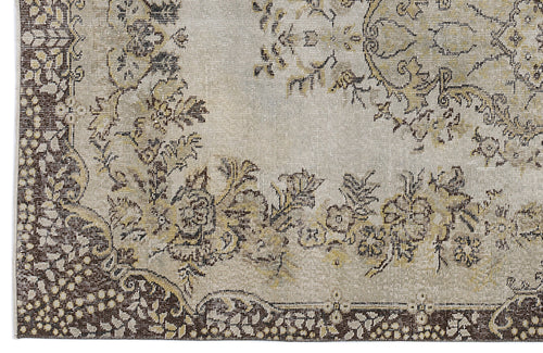 Load image 1 in gallery view. Beige and brown traditional rug with a distressed floral medallion pattern and ornate border.