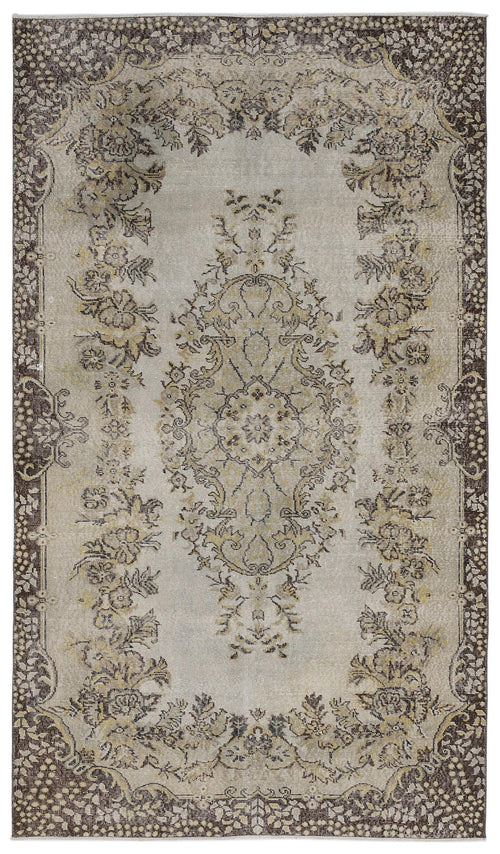 Load image 1 in gallery view. Beige and brown distressed rug with a central floral medallion and ornate botanical border.