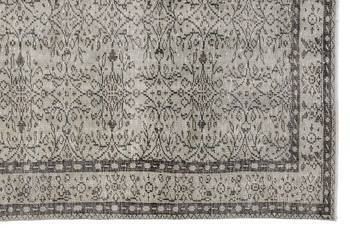 Load image 1 in gallery view. Grey and charcoal distressed rug with a traditional floral medallion pattern and a detailed geometric border.