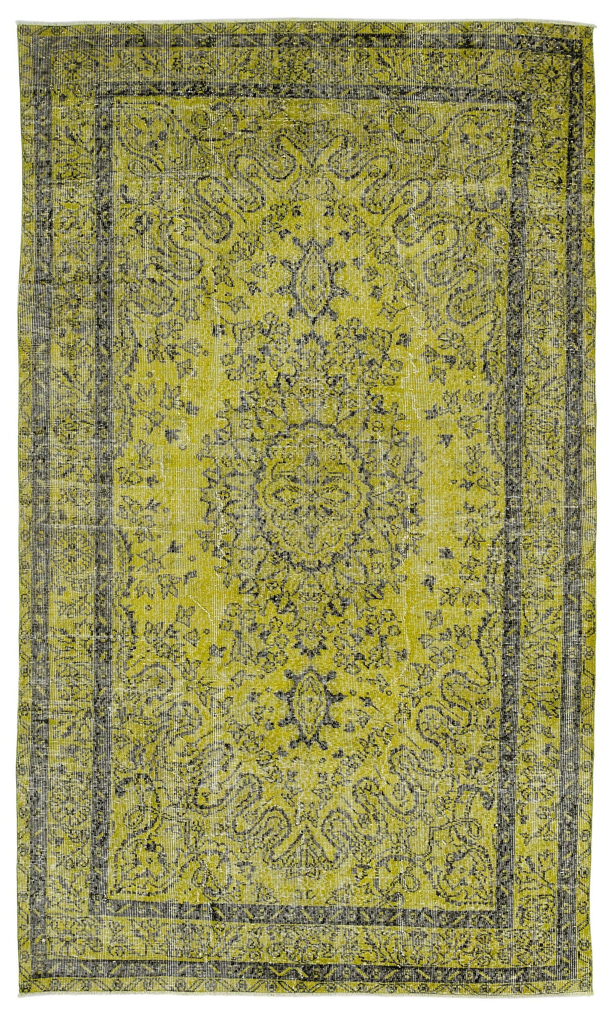 Chartreuse and black distressed vintage-style rug with a central floral medallion and ornate border.