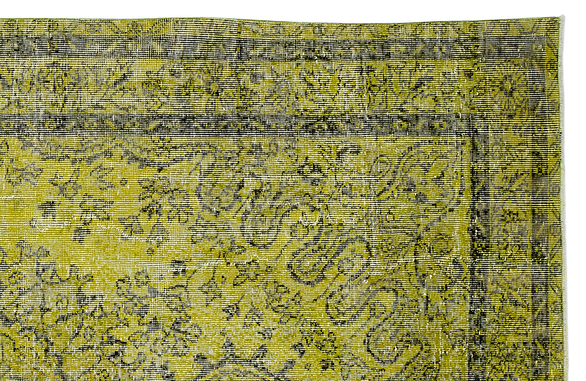 Chartreuse and black distressed rug with a traditional floral medallion pattern and a detailed border.