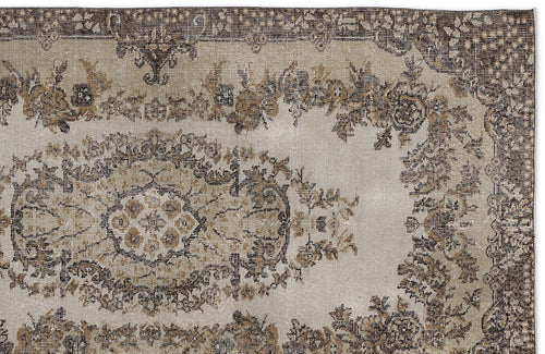 Load image 1 in gallery view. Distressed beige and brown vintage-style rug with a central floral medallion and ornate border.