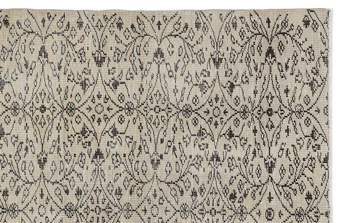 Beige rug with a dark brown repeating floral medallion and diamond lattice pattern.