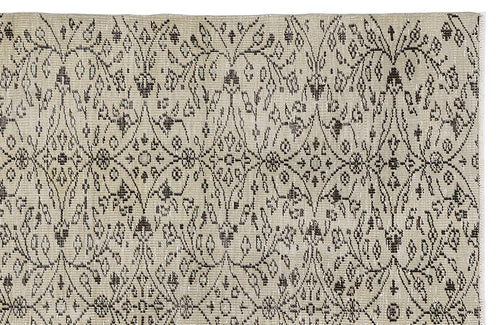 Load image 1 in gallery view. Beige rug with a dark brown repeating floral medallion and diamond lattice pattern.