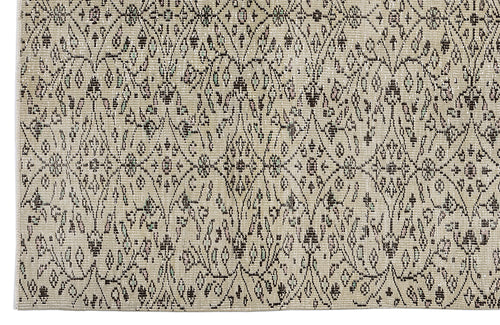 Load image 1 in gallery view. Beige rug with a dark brown distressed diamond lattice pattern featuring small floral and geometric accents.