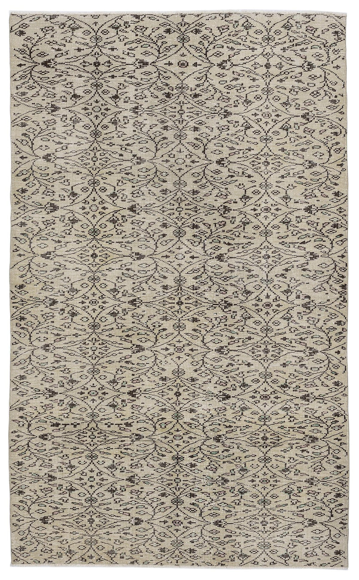 Beige rug with a dark brown, repeating floral trellis pattern and distressed vintage finish.