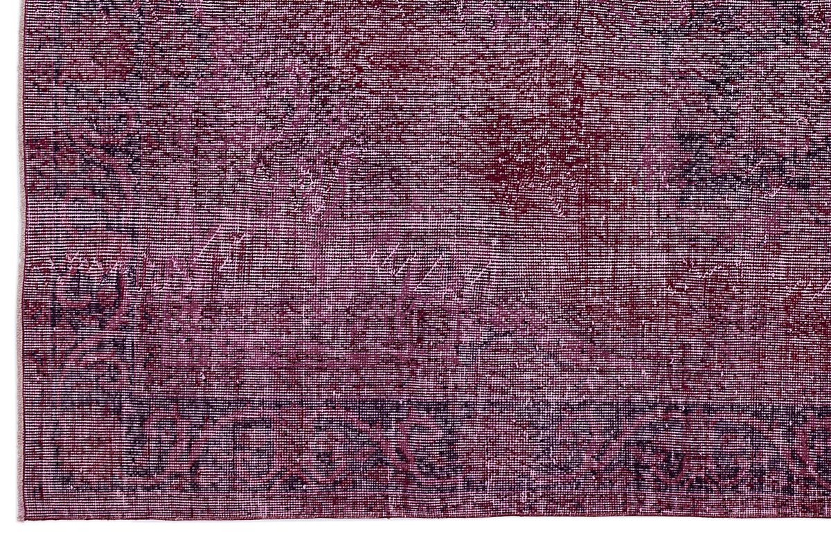 Deep magenta and black distressed vintage-style rug with a faded traditional medallion pattern.