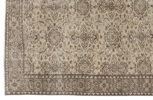 Load image 1 in gallery view. Taupe and brown distressed rug with a traditional floral medallion pattern and a geometric triangle border.