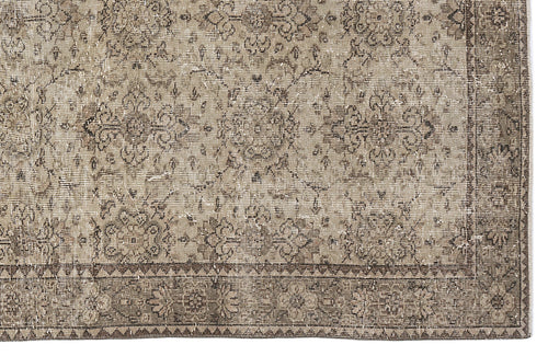 Load image 1 in gallery view. Taupe and beige vintage-style rug with a distressed floral medallion pattern and a geometric border.