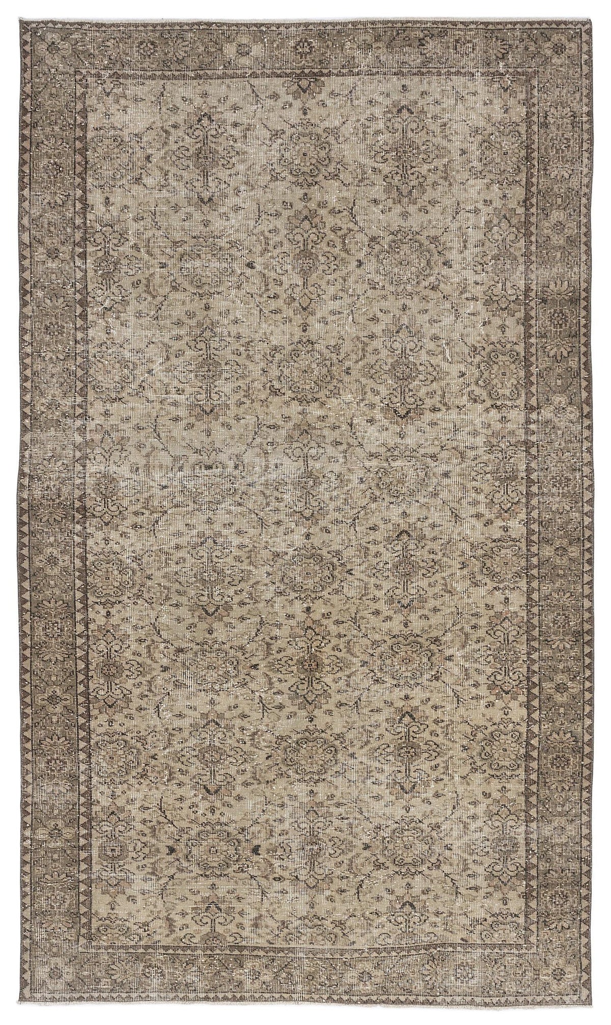 Taupe and brown distressed rug with a traditional floral medallion pattern and a geometric border.