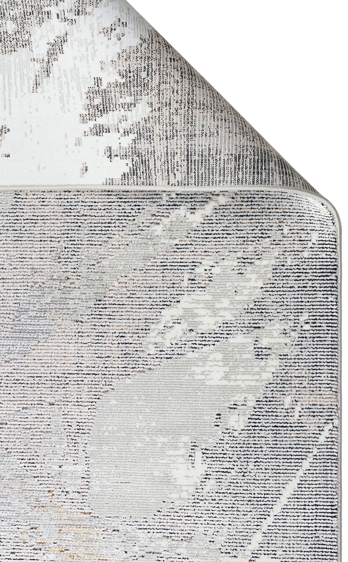 Grey and white area rug with a distressed, abstract linear pattern and a folded corner showing the backing.