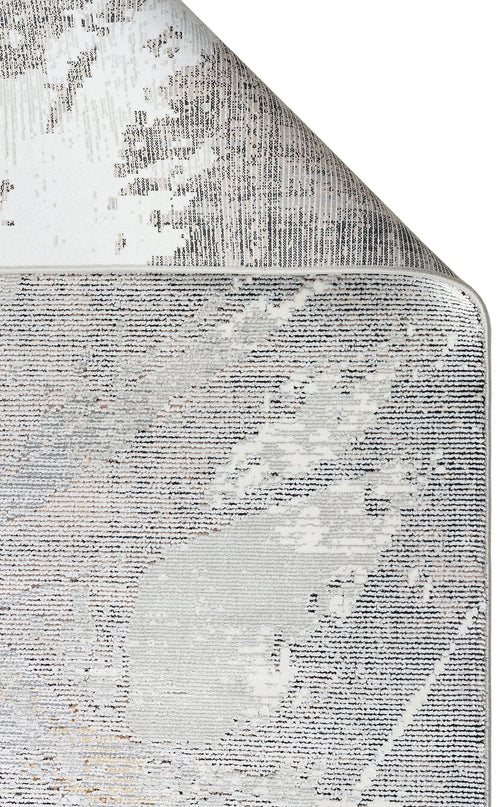 Load image 1 in gallery view. Grey and white area rug with a distressed, abstract linear pattern and a folded corner showing the backing.