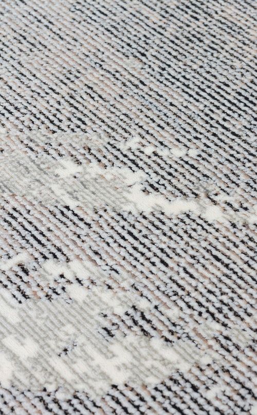 Load image 1 in gallery view. Black, white, and grey textured rug with a linear, distressed abstract pattern.