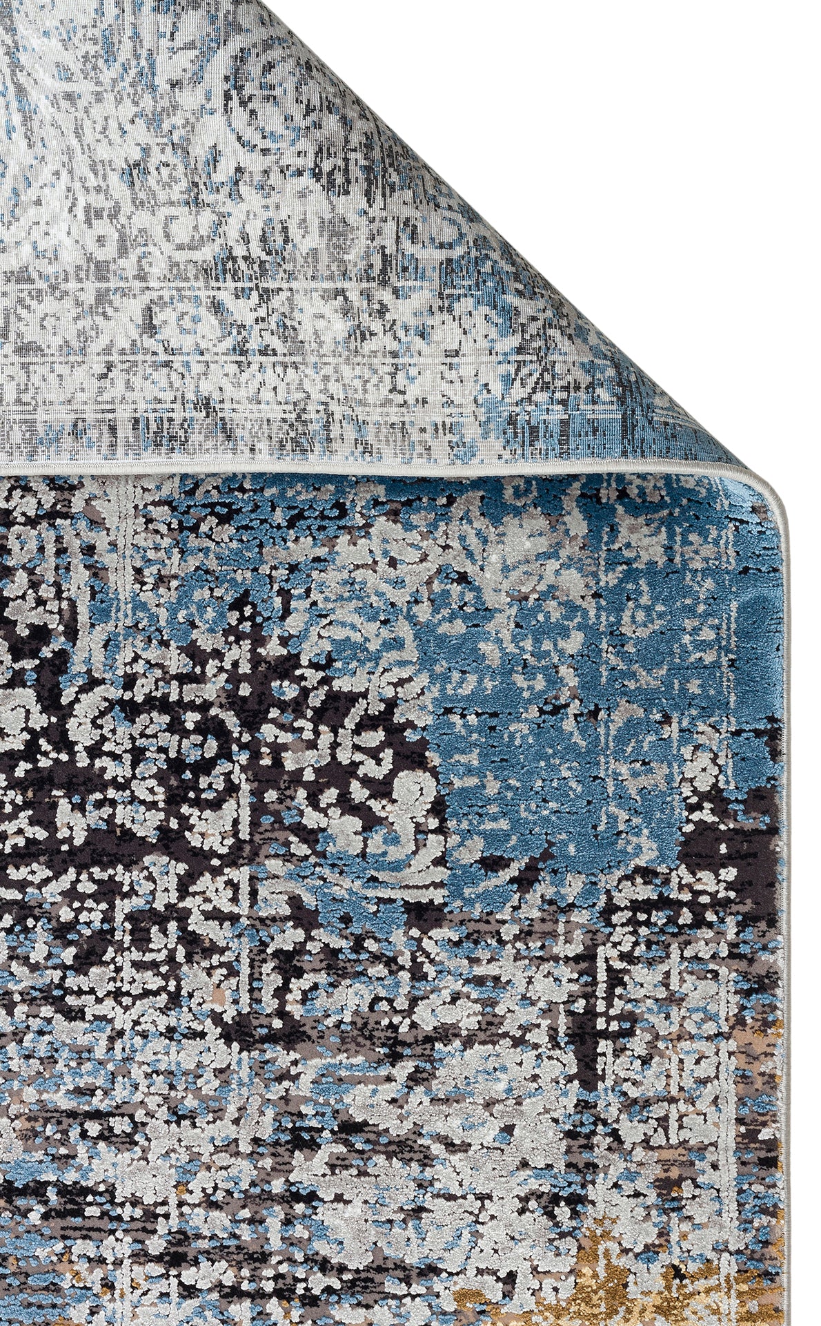 Blue, grey, and charcoal distressed abstract rug with a folded corner on a white background.