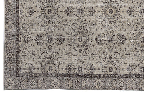 Load image 1 in gallery view. Grey and charcoal distressed rug with a traditional floral medallion pattern and a wide decorative border.