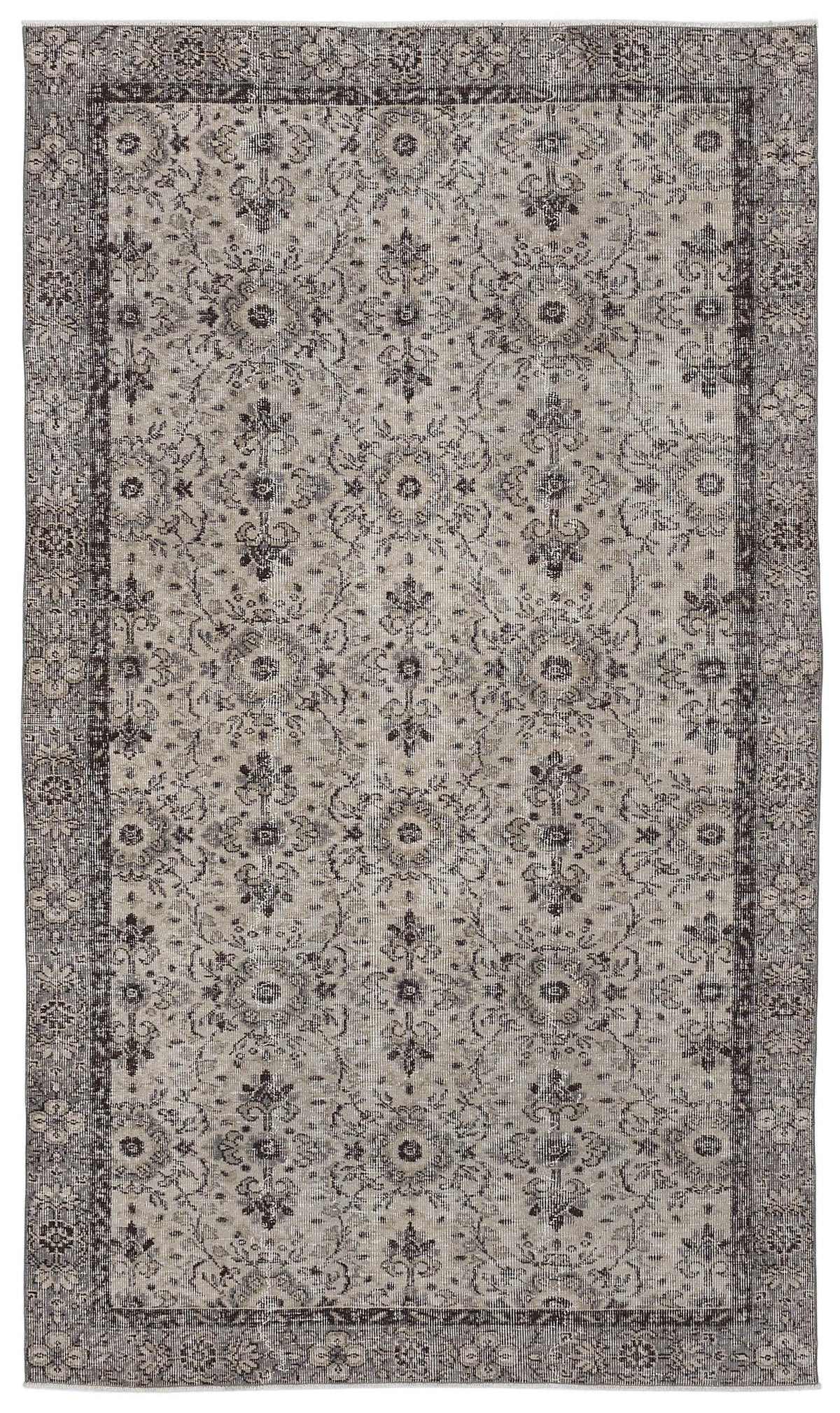 Grey and charcoal distressed rug with a traditional floral medallion pattern and a wide decorative border.
