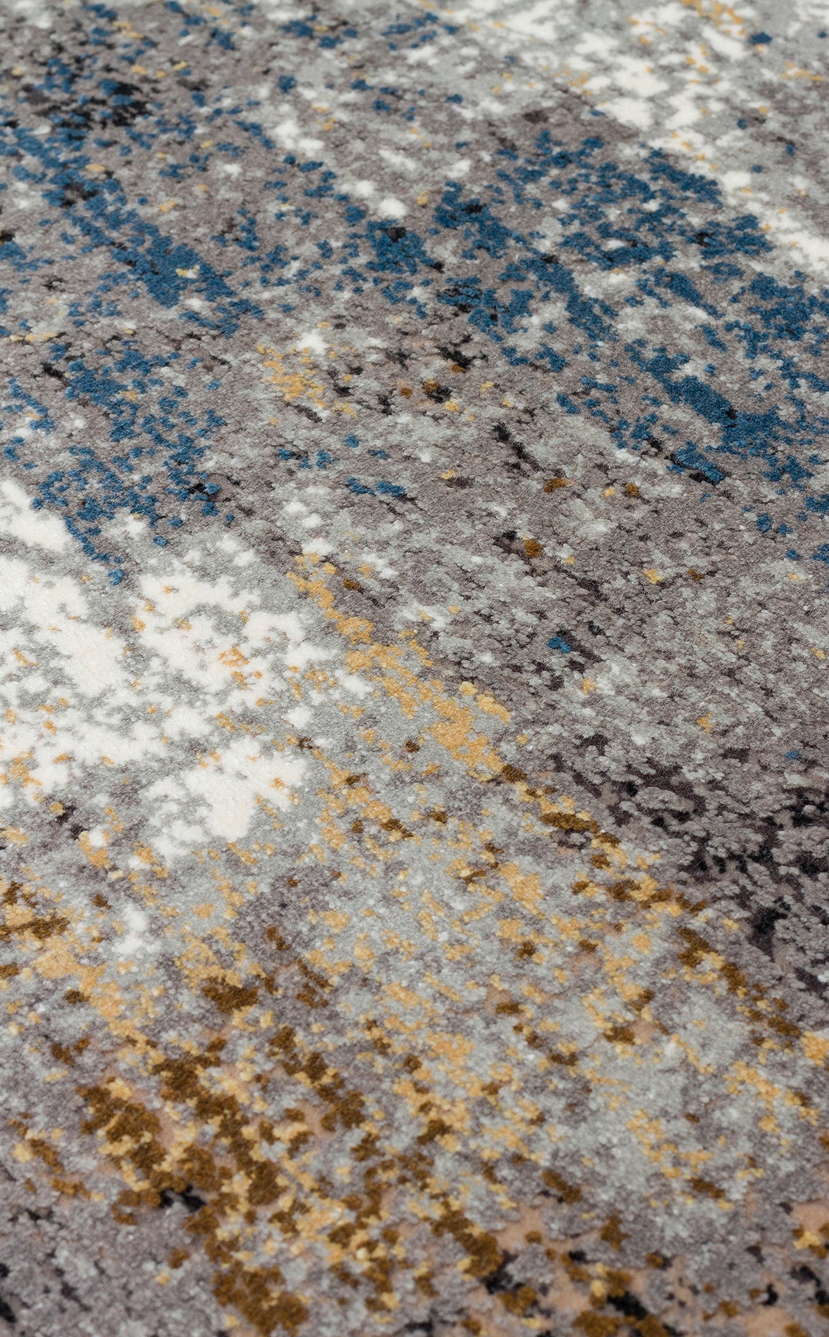 Grey, blue, and gold abstract area rug with a distressed, textured pile.