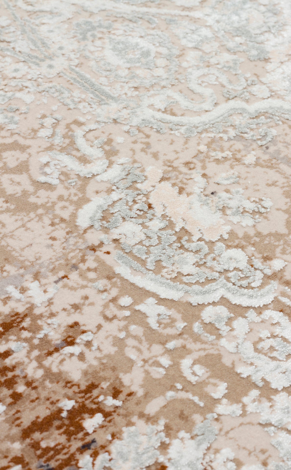 Beige and cream rug with a distressed, faded traditional floral medallion pattern and textured pile.