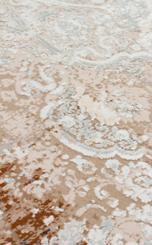 Load image 1 in gallery view. Beige and cream rug with a distressed, faded traditional floral medallion pattern and textured pile.