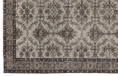 Load image 1 in gallery view. Grey and dark brown rug with a distressed traditional floral medallion pattern and a geometric border.