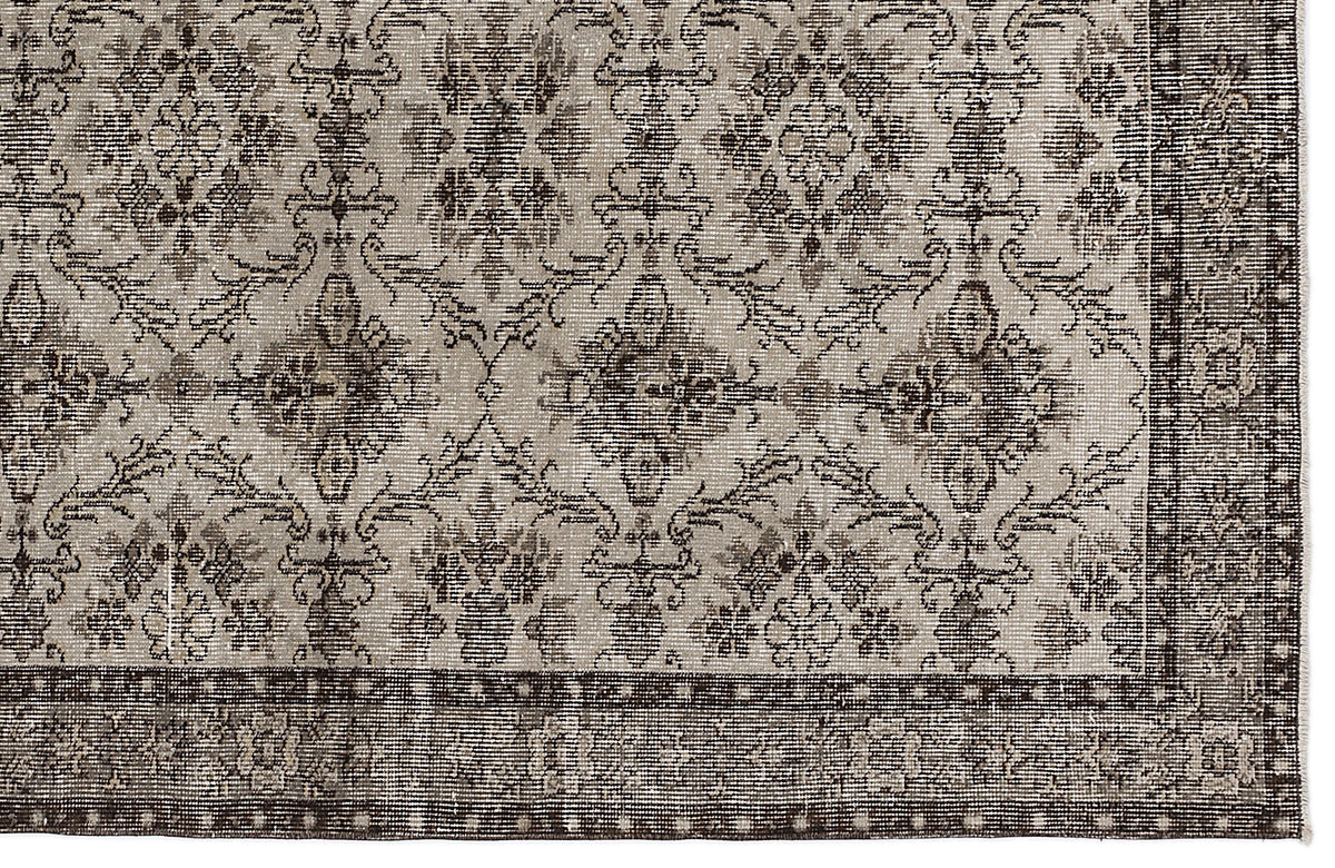 Taupe and dark brown rug with a traditional floral medallion pattern and a wide, detailed border.