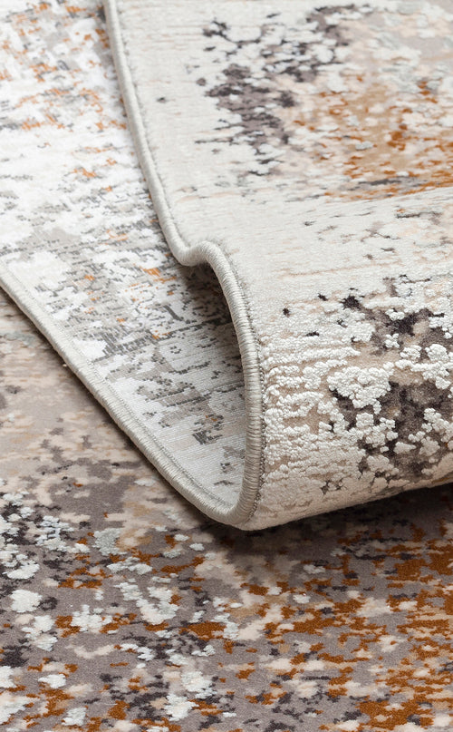 Load image 1 in gallery view. Cream, grey, and rust-colored abstract area rug with a distressed, mottled texture and serged edges.