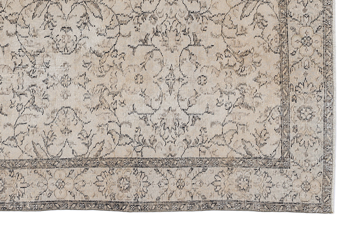 Beige and charcoal grey rug with a distressed traditional floral medallion pattern and a detailed border.